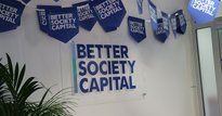Better Society Capital logo on wall and blue bunting