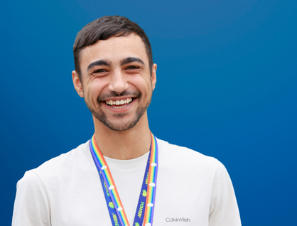 P2 staff member smiling against a blue background
