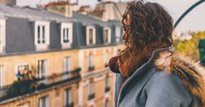 Woman looking over UK housing