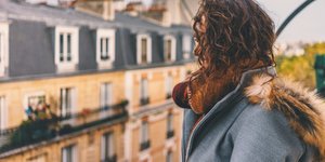 Woman looking over UK housing