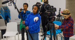 Three children using camera equipment